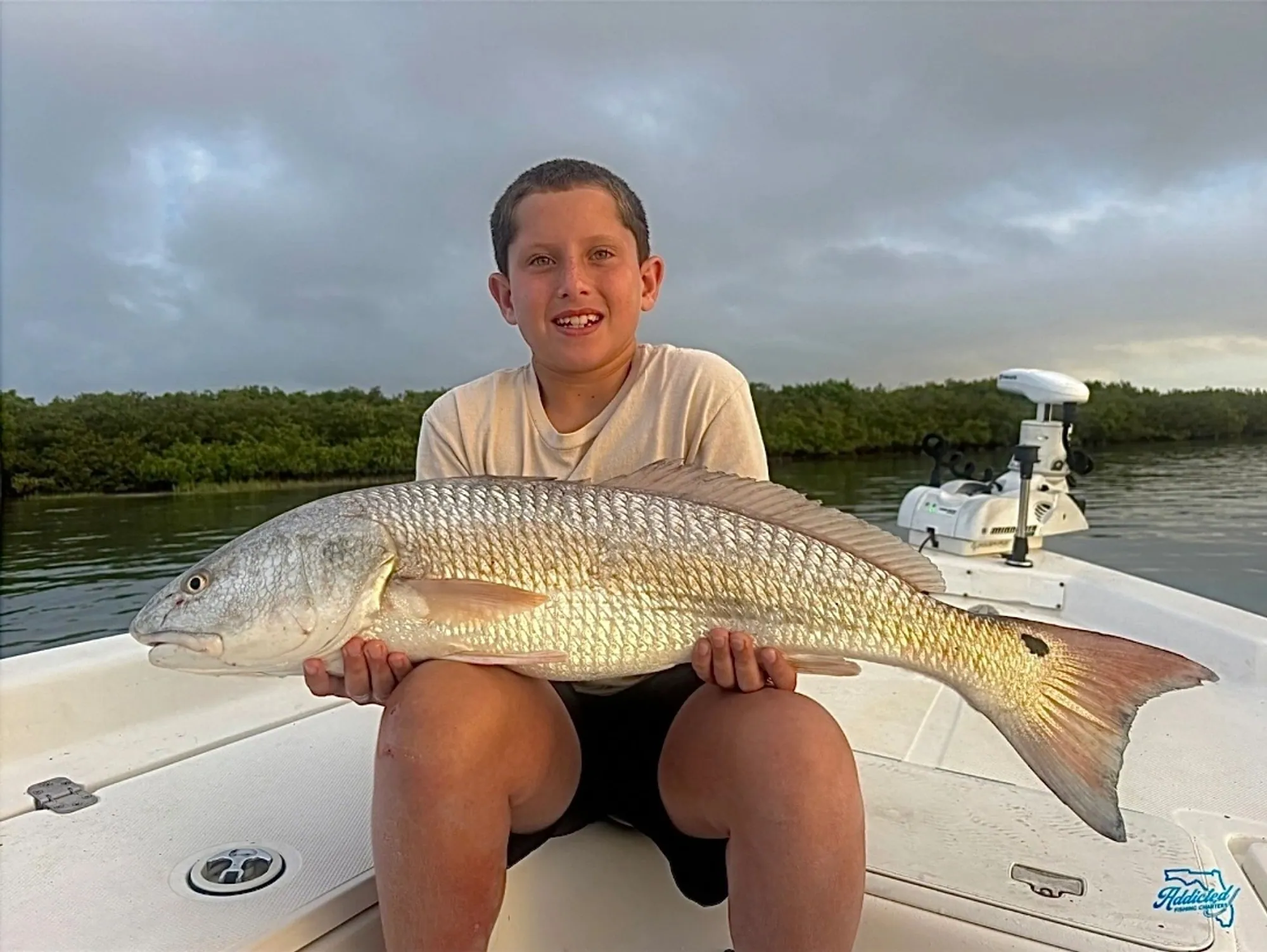 Female angler with a trophy redfish caught on Mosquito Lagoon