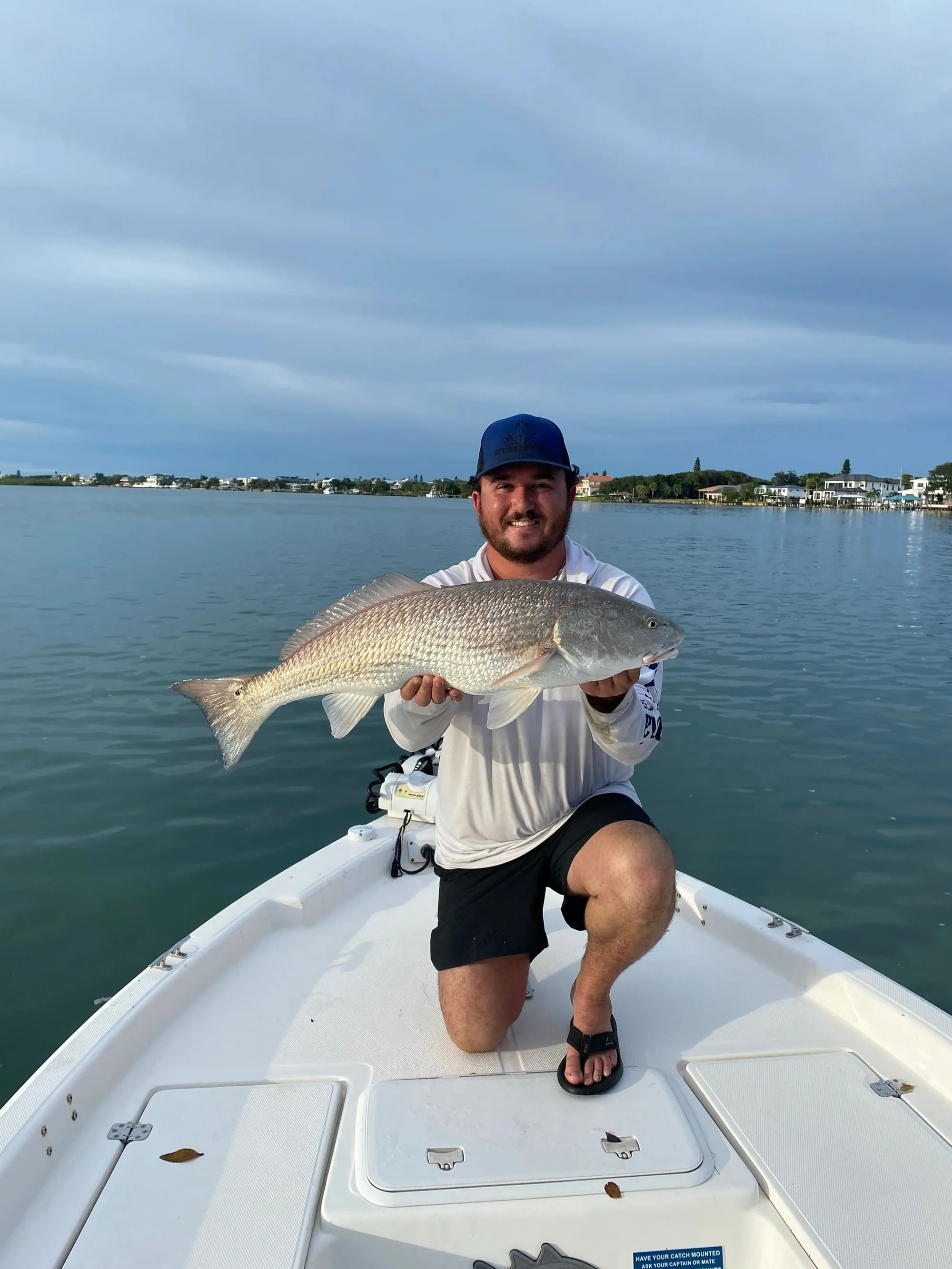 Angler smiling with a black drum caught inshore