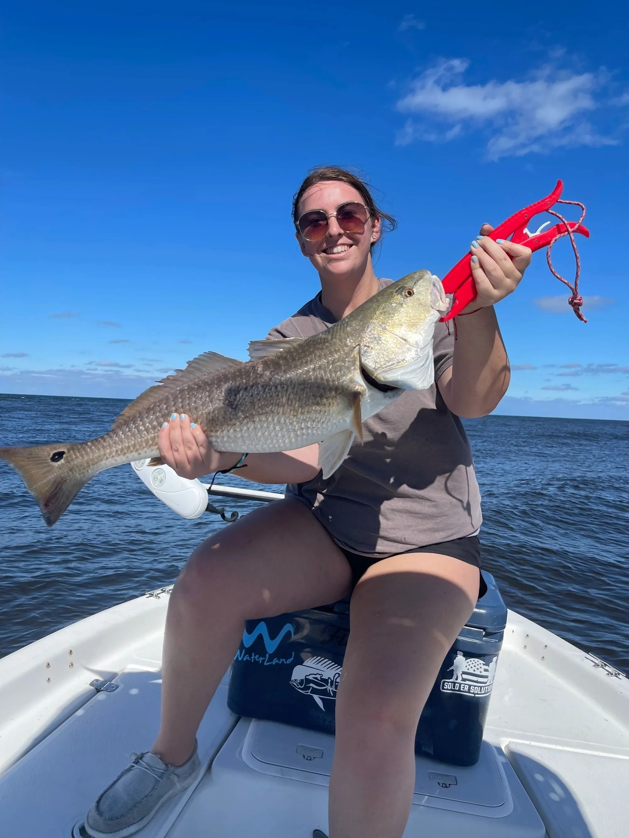 Customer with personal-best redfish on a New Smyrna Beach trip