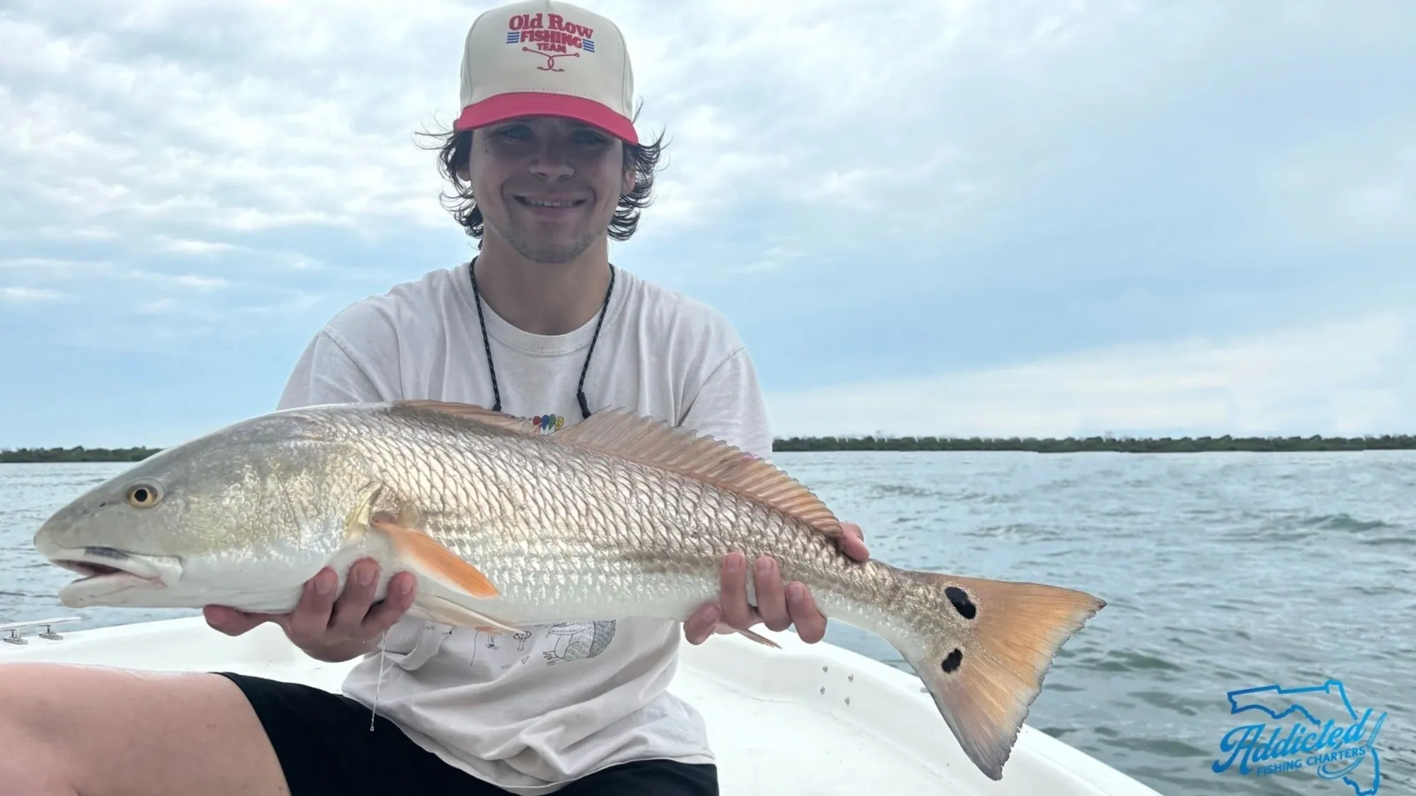 Happy client with a redfish on a Mosquito Lagoon trip