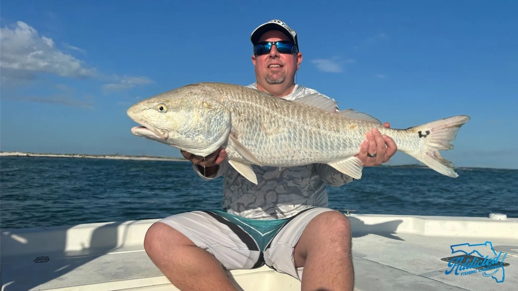 Charter client pose with a nice slot redfish